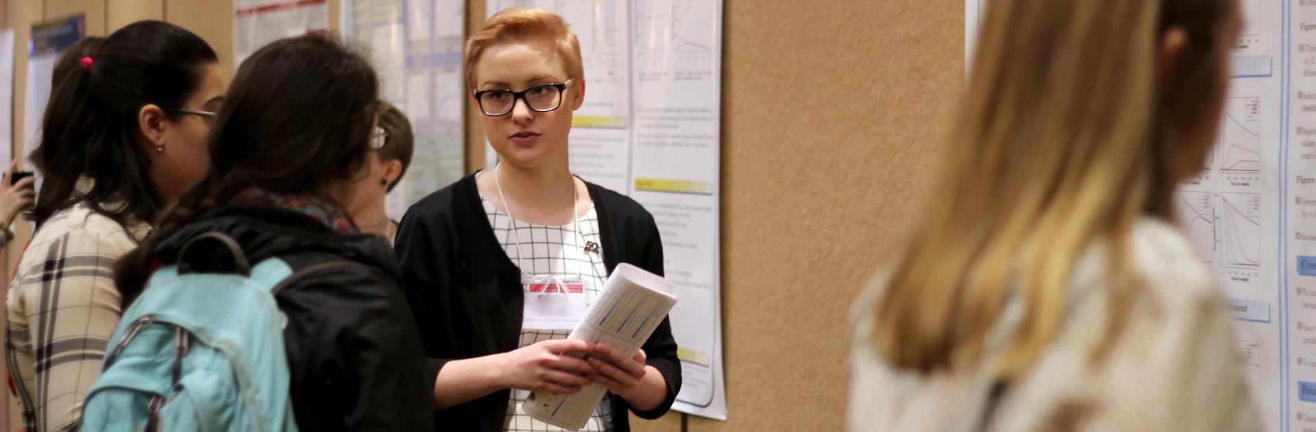 A conference presenter at the NCUWM poster session